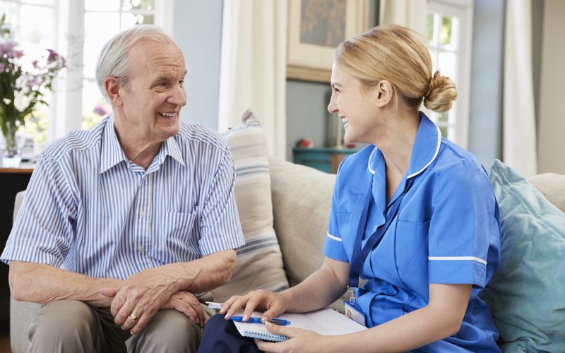 Female Community Nurse Visits Senior Man At Home